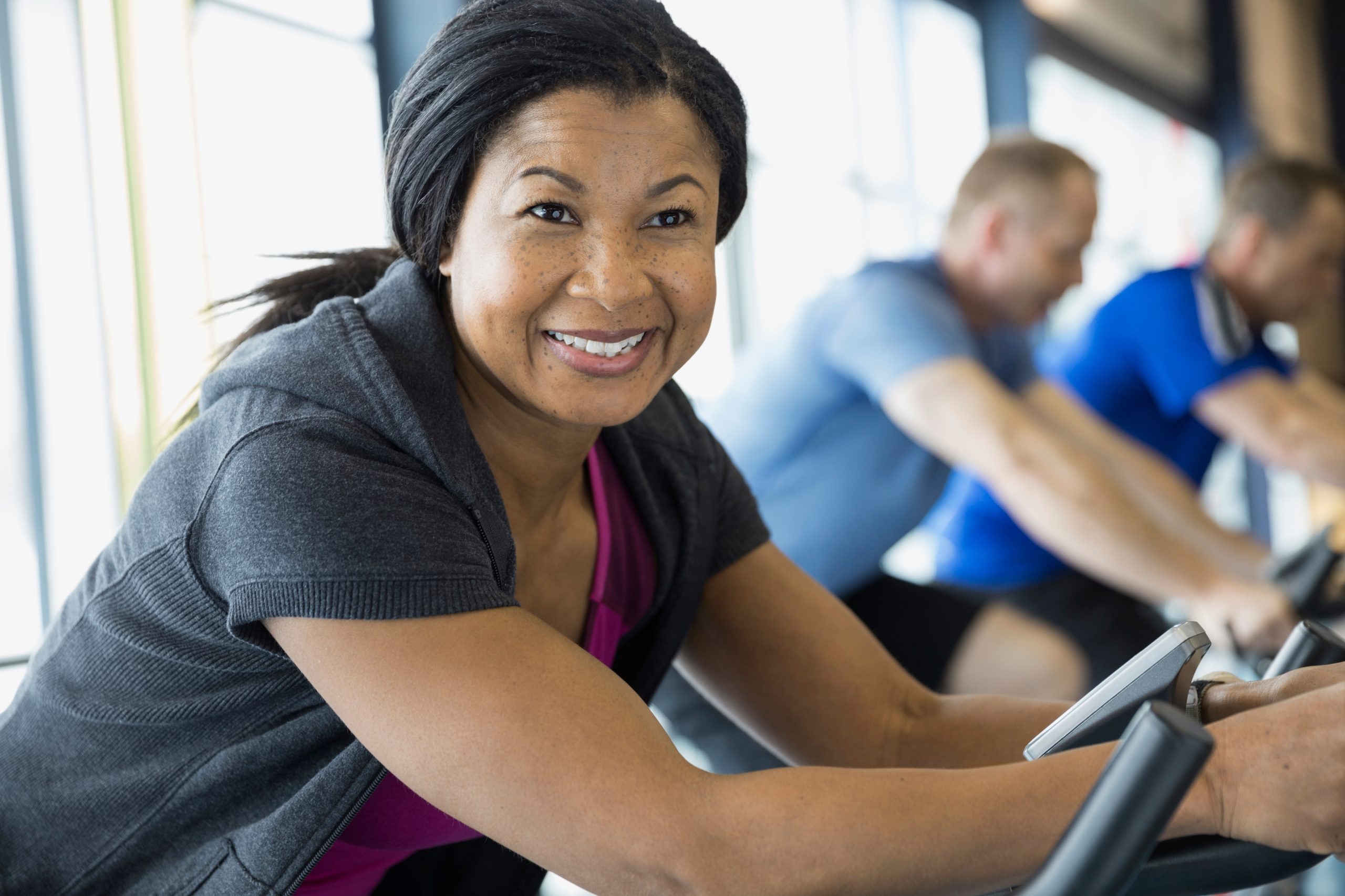 Woman training on exercise bike — know your numbers, train with precision